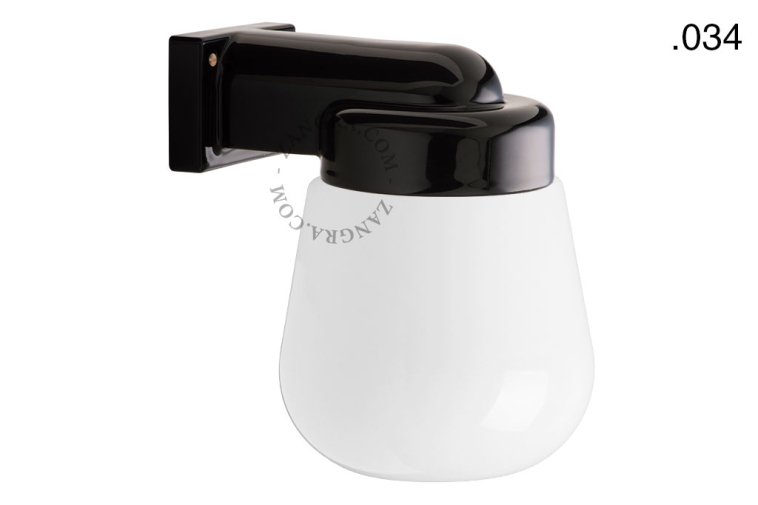 Black porcelain wall light with glass globe for bathroom or outdoor use.