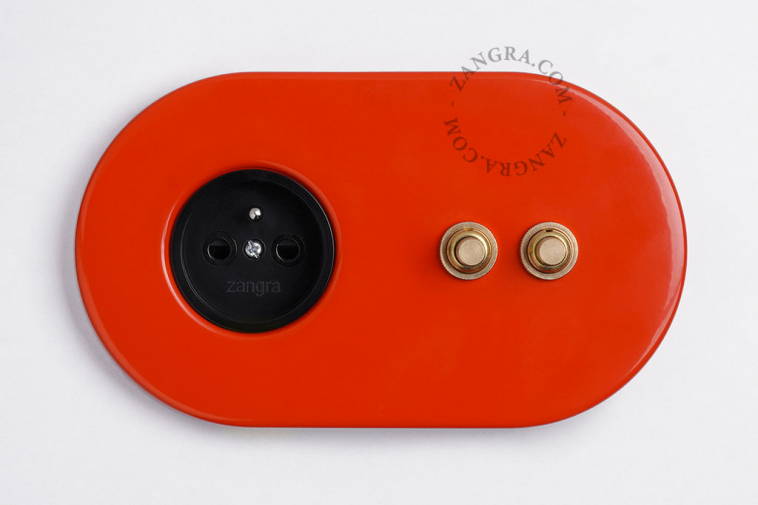 2 gold push buttons on red integrated outlet